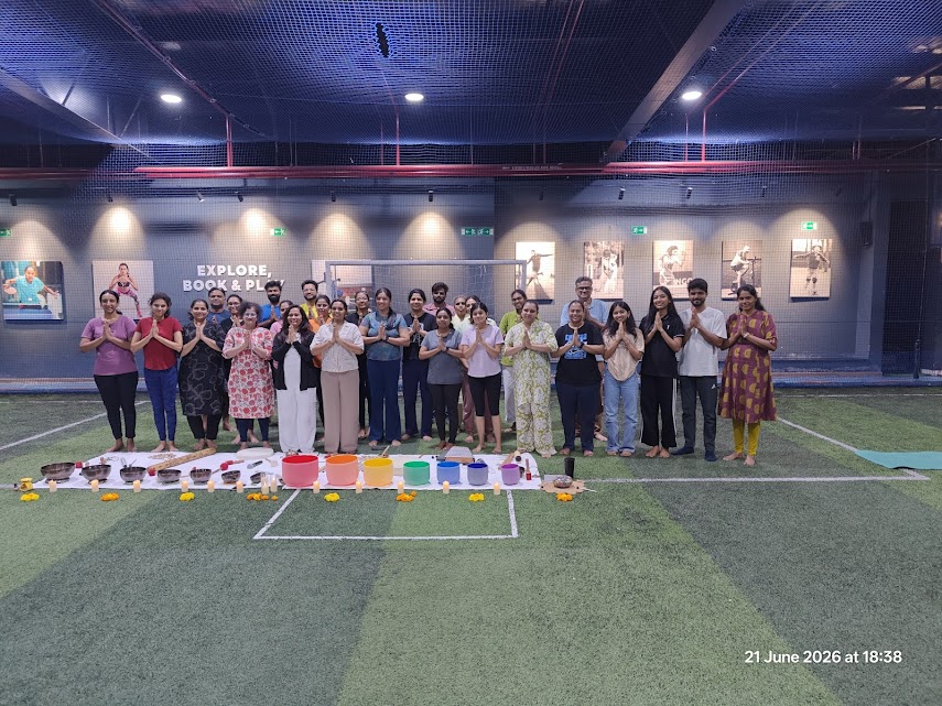 International Yoga Day Event Sound Bath and Chakra Healing 21st June 2026 Bangalore - Group Namaste with all 7 Chakra Crystal Bowls, marigolds and accessories - Yoga With Jigisha Bengaluru India